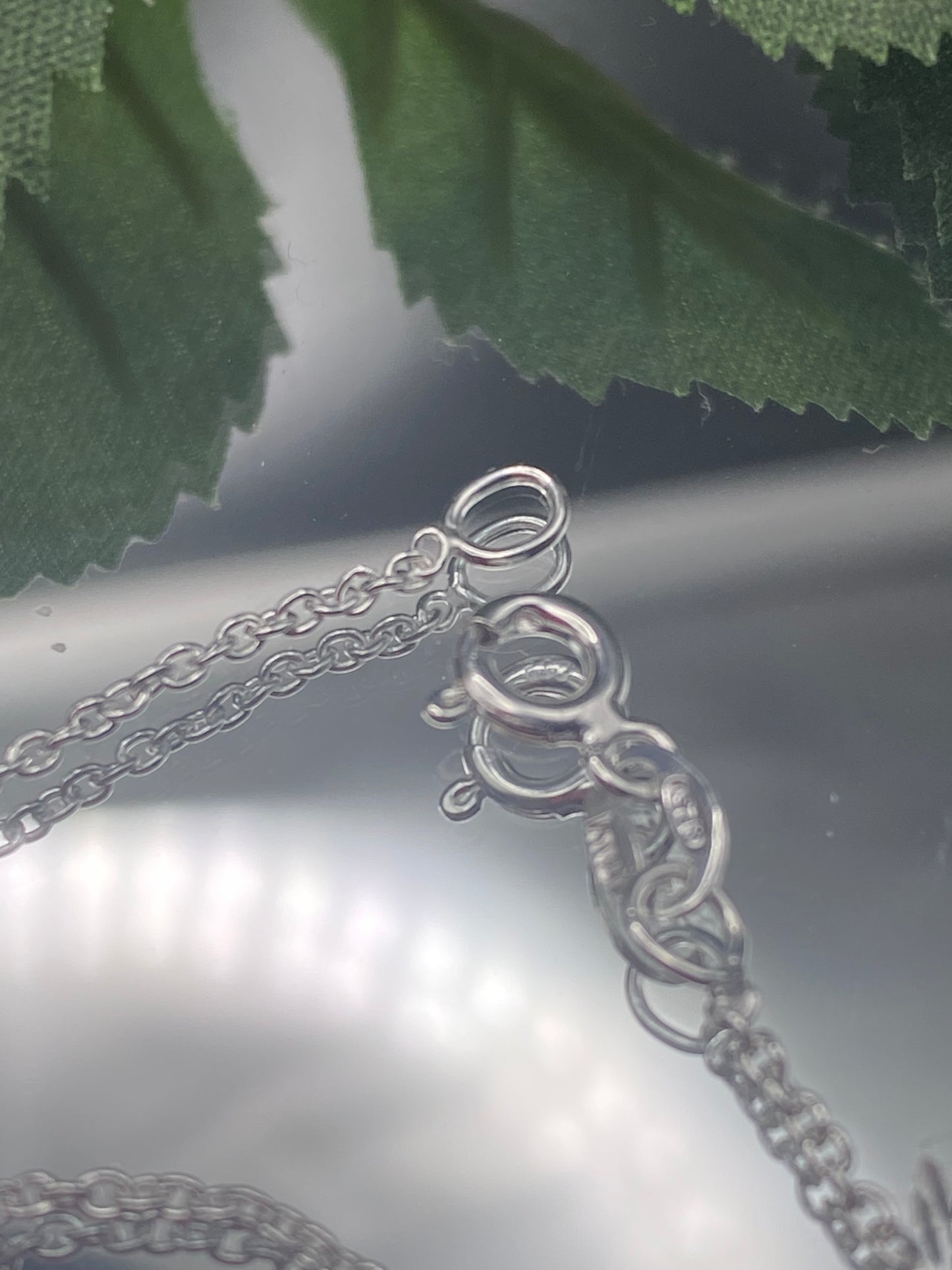 May include: A Sterling silver chain necklace with a lobster clasp closure.