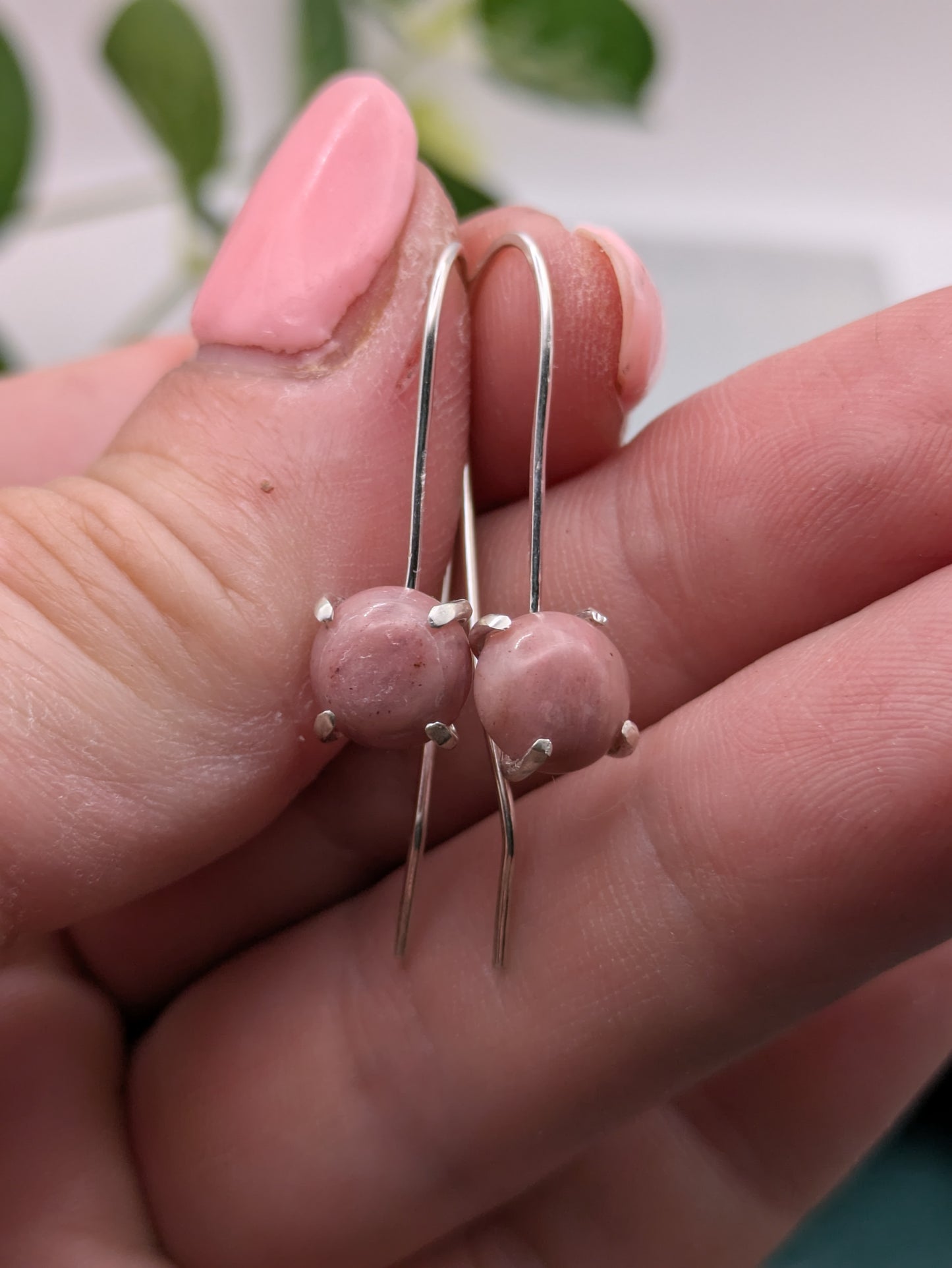 <img src="rhodonite-earrings.jpg" alt="Handmade rhodonite earrings in recycled sterling silver, pink crystal drops for emotional healing and self-love">