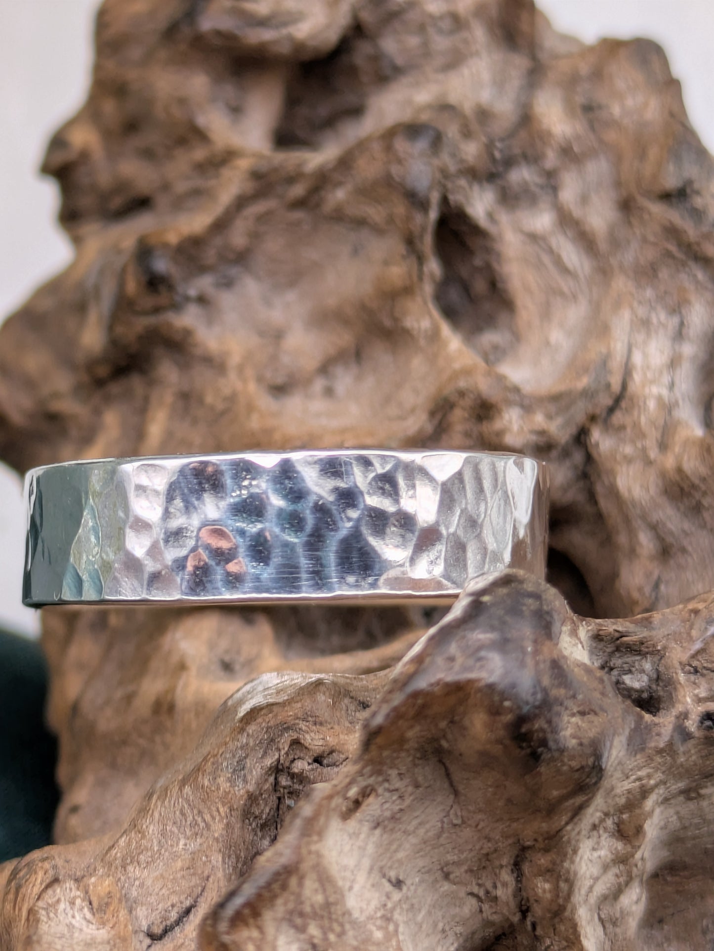 <img src="hammered-silver-ring.jpg" alt="Handcrafted 6mm sterling silver ring with hammered texture, a bold and unique statement band made from recycled 925 silver">