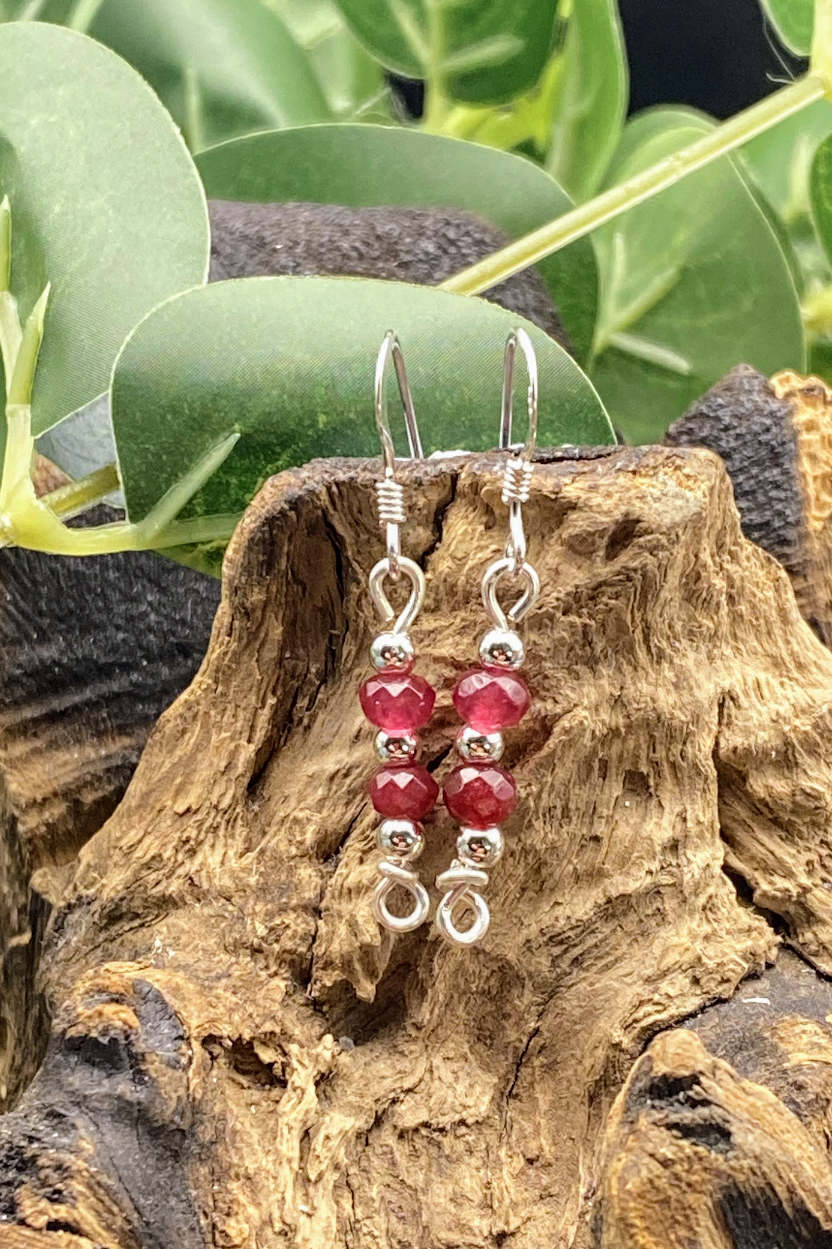 html
<img src="ruby-earrings.jpg" alt="Dainty ruby red gemstone earrings handcrafted in sterling silver, delicate crystal drops for passion and elegance">