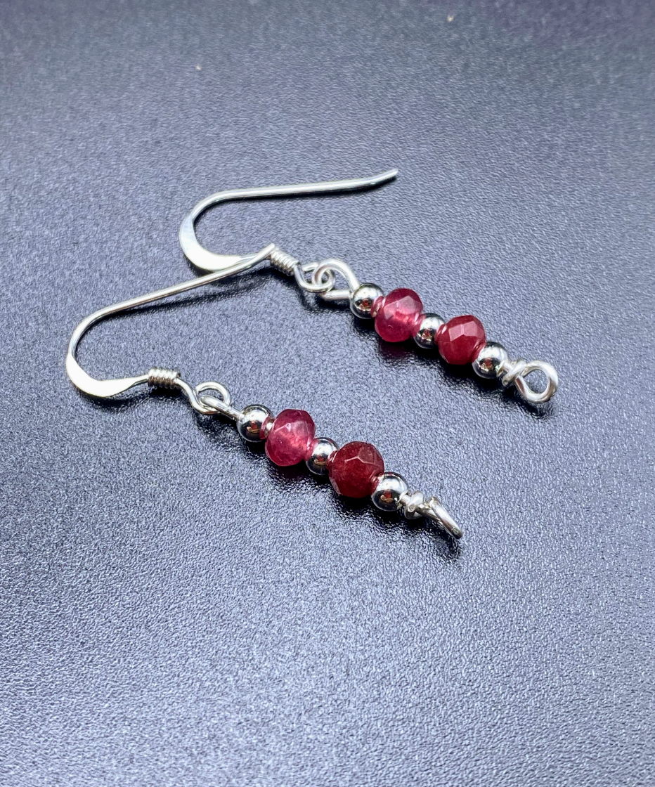 html
<img src="ruby-earrings.jpg" alt="Dainty ruby red gemstone earrings handcrafted in sterling silver, delicate crystal drops for passion and elegance">
