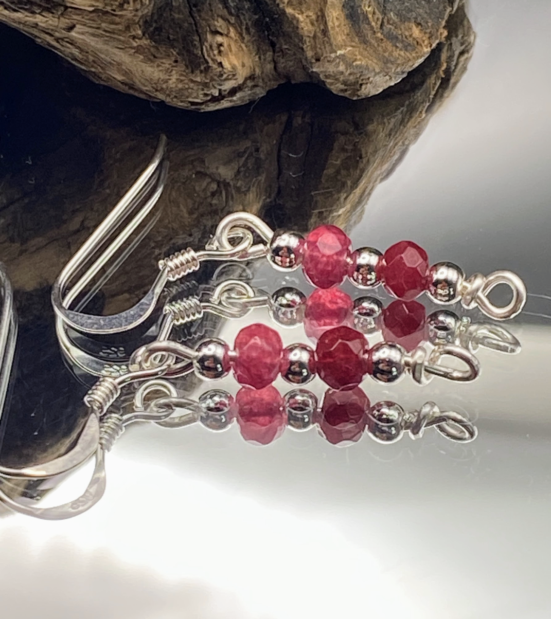 html
<img src="ruby-earrings.jpg" alt="Dainty ruby red gemstone earrings handcrafted in sterling silver, delicate crystal drops for passion and elegance">