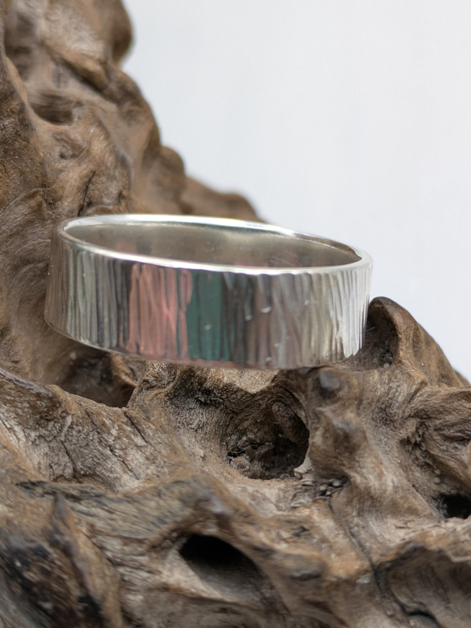 <img src="bark-effect-ring.jpg" alt="Handcrafted 6mm sterling silver ring with bark-inspired hammered texture, a bold and earthy statement band made from recycled 925 silver">