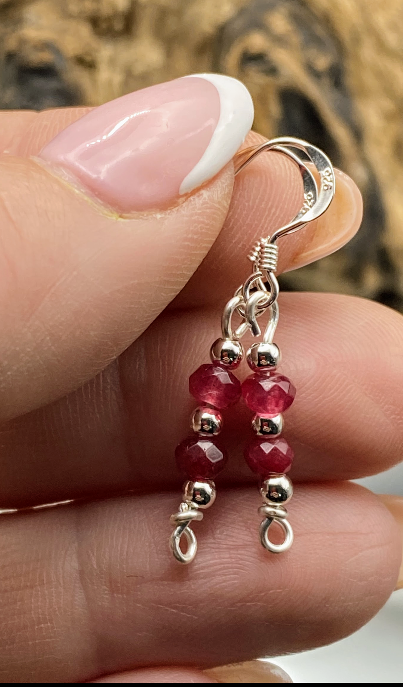 html
<img src="ruby-earrings.jpg" alt="Dainty ruby red gemstone earrings handcrafted in sterling silver, delicate crystal drops for passion and elegance">