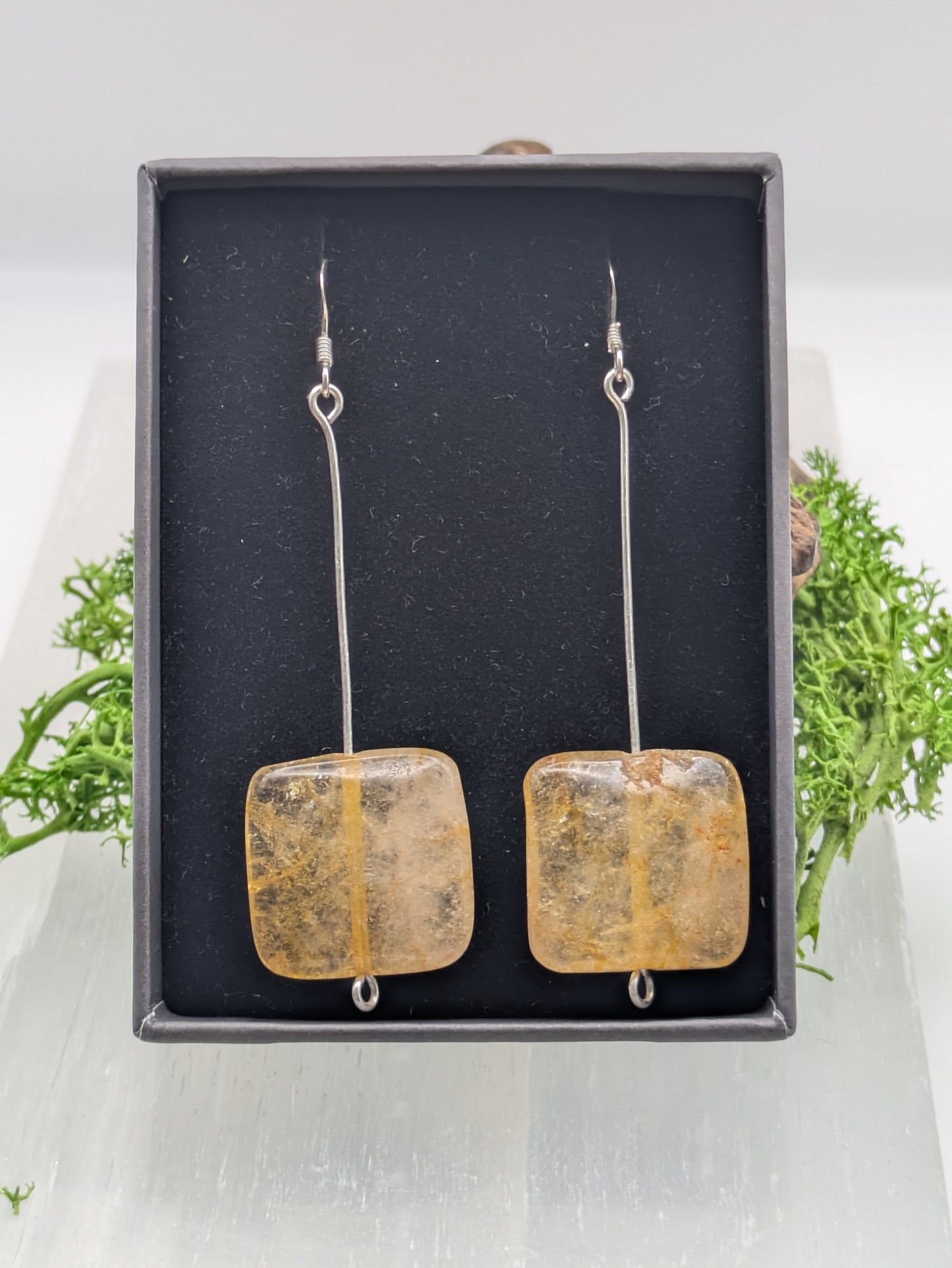 Hand-wrapped Citrine earrings in silver, glowing with golden warmth and elegant craftsmanship