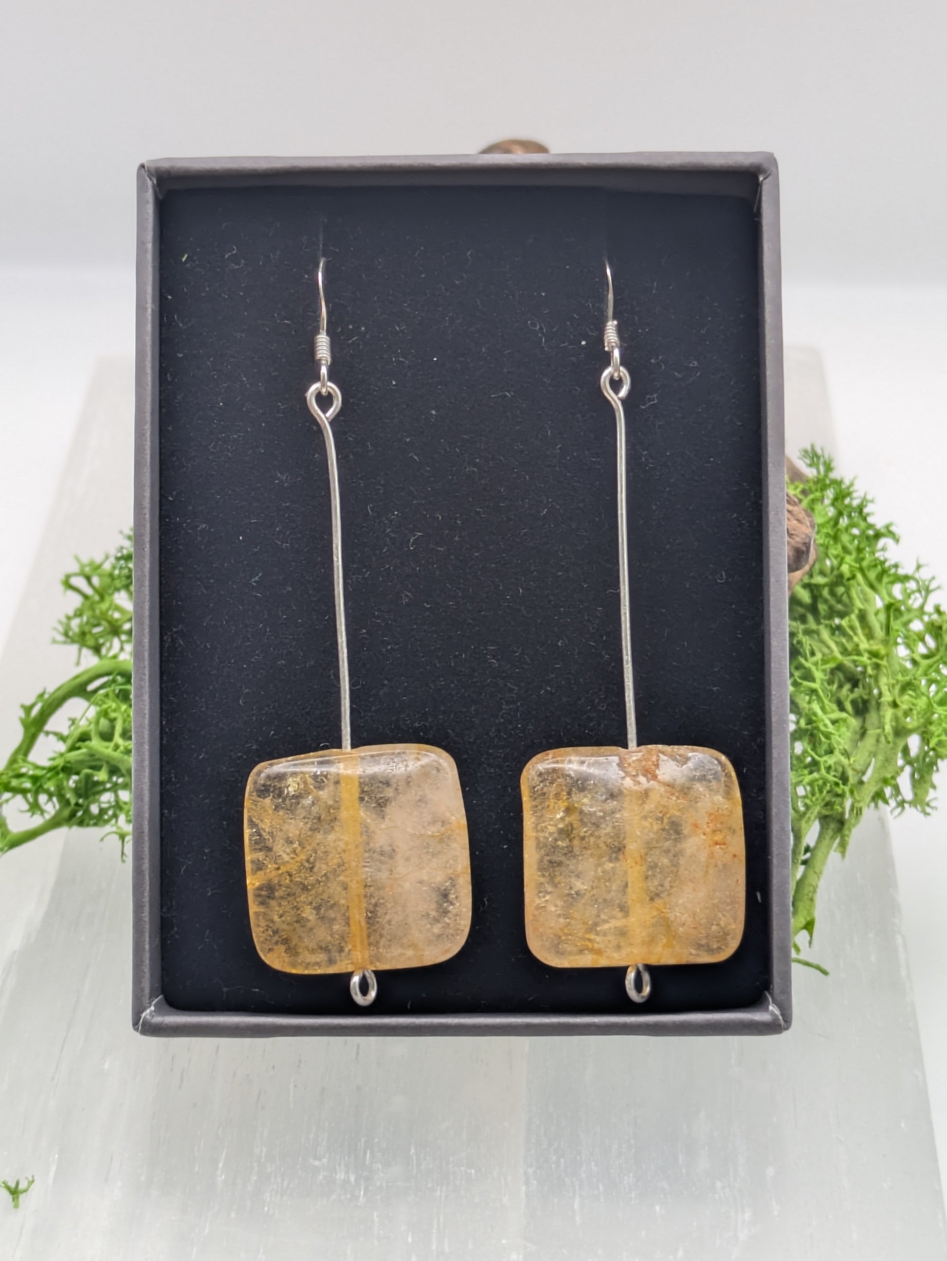 Hand-wrapped Citrine earrings in silver, glowing with golden warmth and elegant craftsmanship