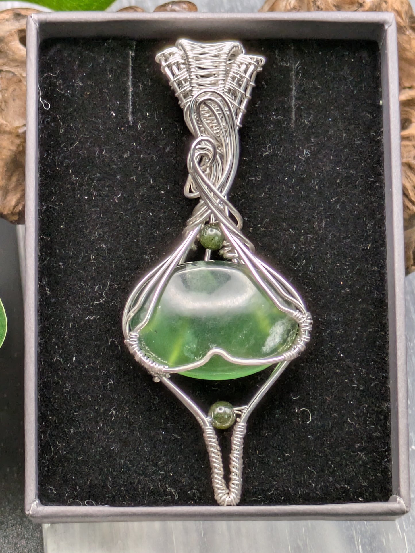 <img src="indonesian-jade-pendant.jpg" alt="Handmade Indonesian jade pendant wrapped in recycled sterling silver, a unique statement crystal necklace inspired by nature">