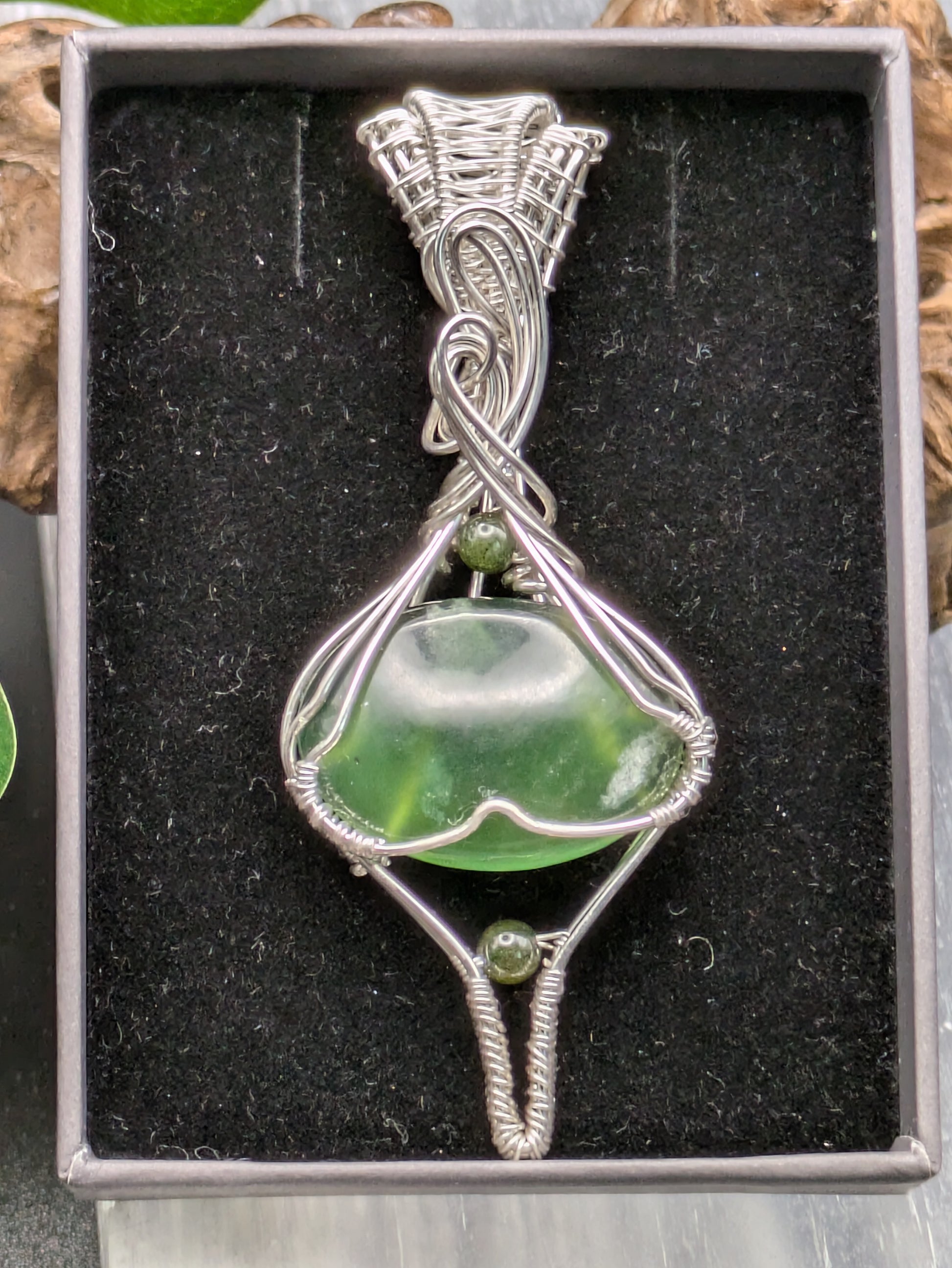<img src="indonesian-jade-pendant.jpg" alt="Handmade Indonesian jade pendant wrapped in recycled sterling silver, a unique statement crystal necklace inspired by nature">