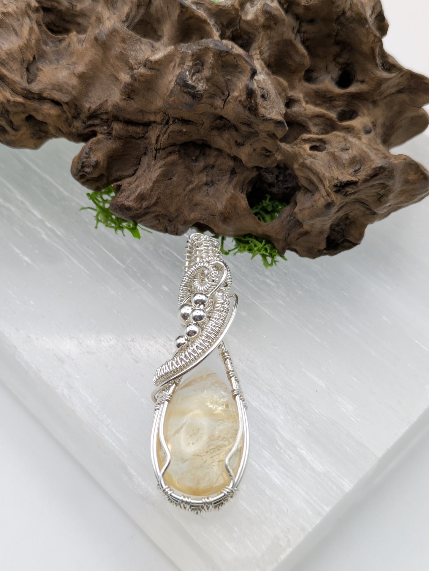 Hand-wrapped Citrine pendant in sterling silver, glowing with golden hues and artisanal detail