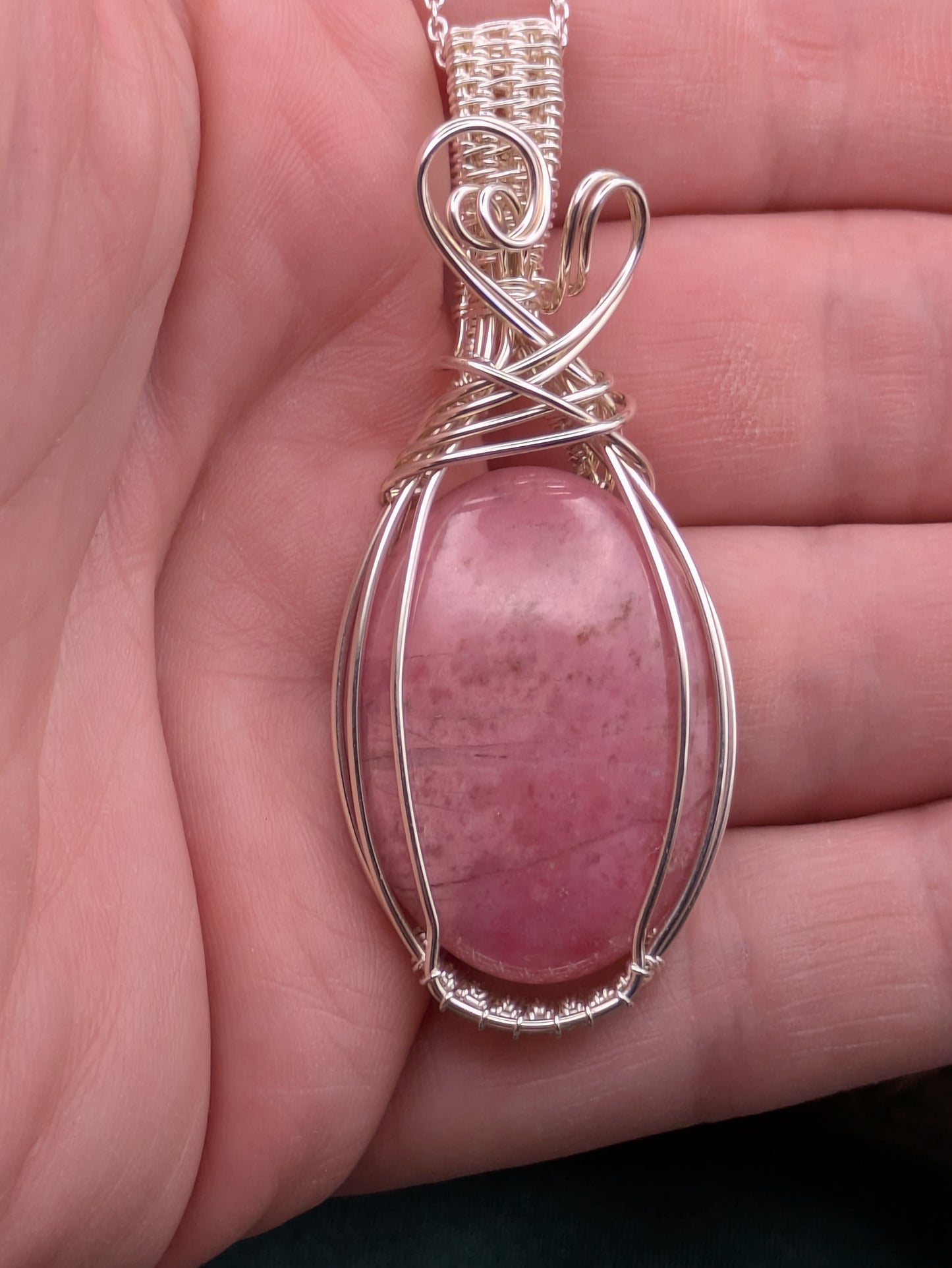 Handcrafted rhodonite pendant in sterling silver symbolising love, healing, and emotional strength
