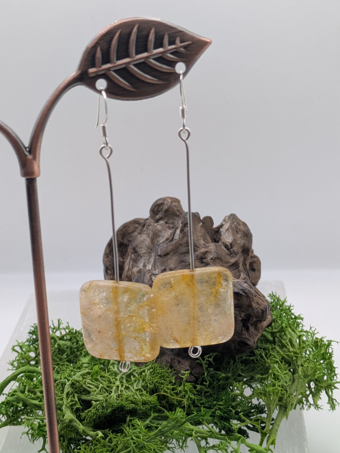 Hand-wrapped Citrine earrings in silver, glowing with golden warmth and elegant craftsmanship