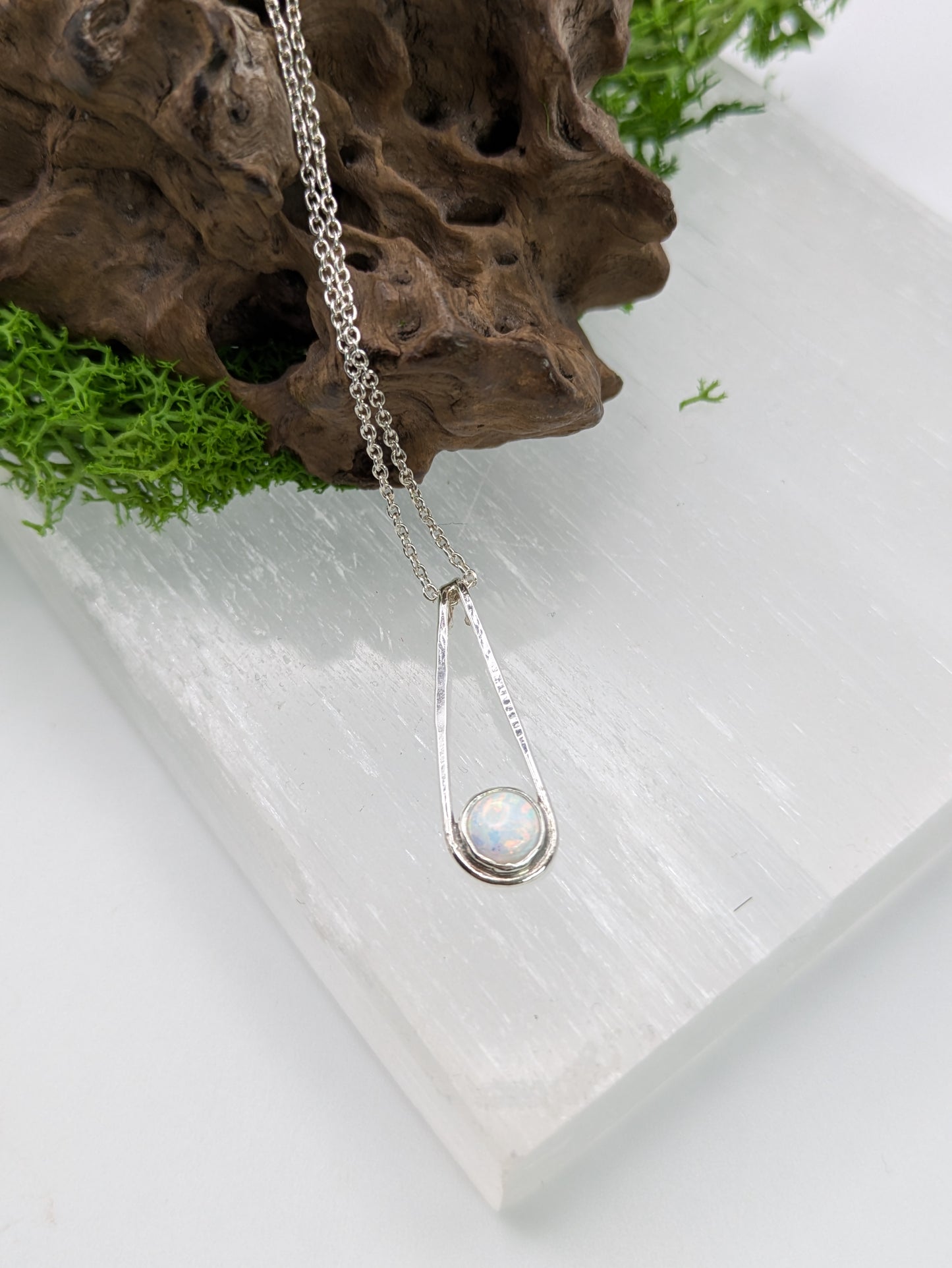  Sterling silver pendant in a Teardrop shape with a glowing Kyocera opal in soft pink and blue tones, fully hallmarked and displayed on a neutral background.