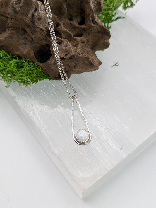  Sterling silver pendant in a Teardrop shape with a glowing Kyocera opal in soft pink and blue tones, fully hallmarked and displayed on a neutral background.