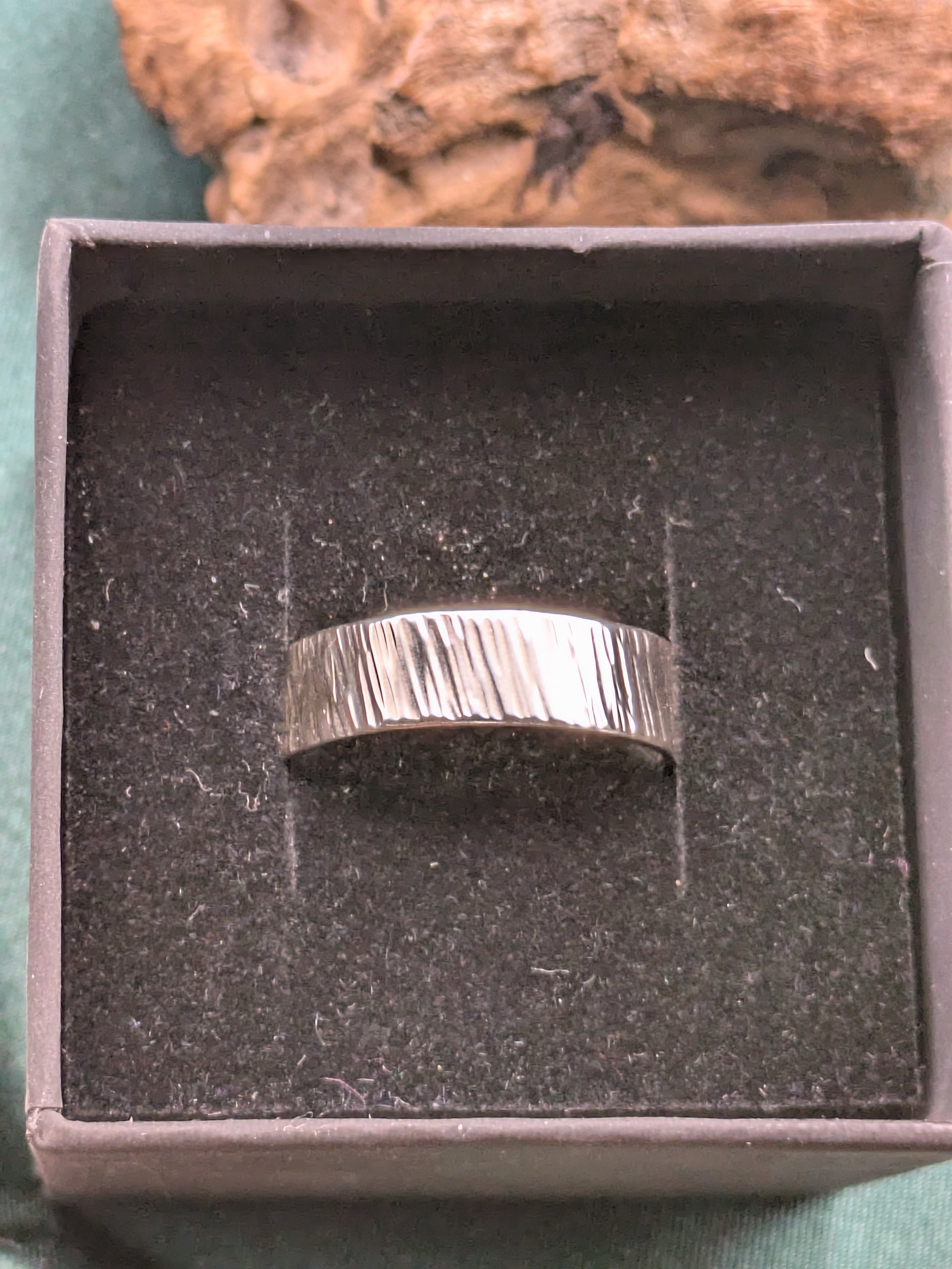 <img src="bark-effect-ring.jpg" alt="Handcrafted 6mm sterling silver ring with bark-inspired hammered texture, a bold and earthy statement band made from recycled 925 silver">
