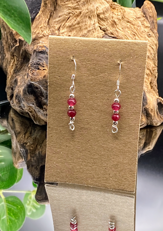 html
<img src="ruby-earrings.jpg" alt="Dainty ruby red gemstone earrings handcrafted in sterling silver, delicate crystal drops for passion and elegance">