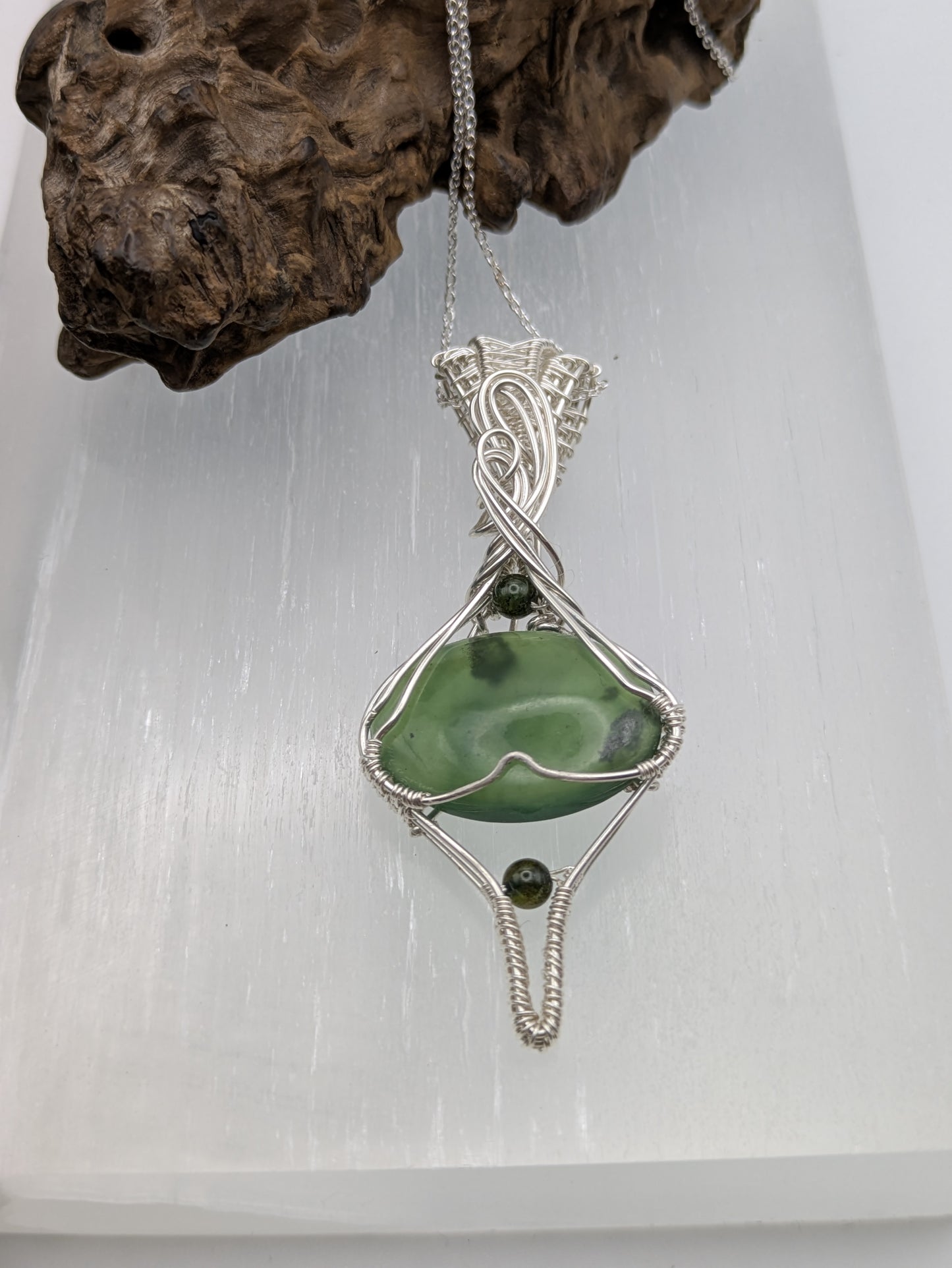 <img src="indonesian-jade-pendant.jpg" alt="Handmade Indonesian jade pendant wrapped in recycled sterling silver, a unique statement crystal necklace inspired by nature">