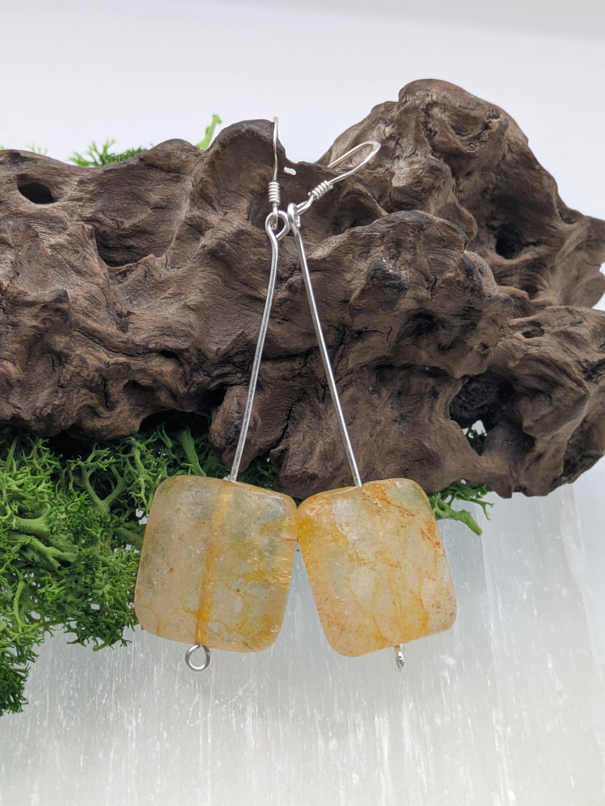 Hand-wrapped Citrine earrings in silver, glowing with golden warmth and elegant craftsmanship