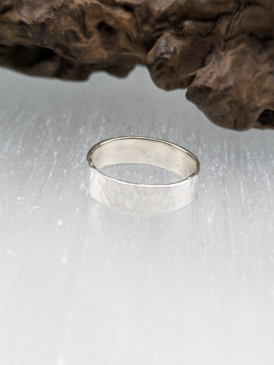 <img src="hammered-silver-ring.jpg" alt="Handcrafted 6mm sterling silver ring with hammered texture, a bold and unique statement band made from recycled 925 silver">