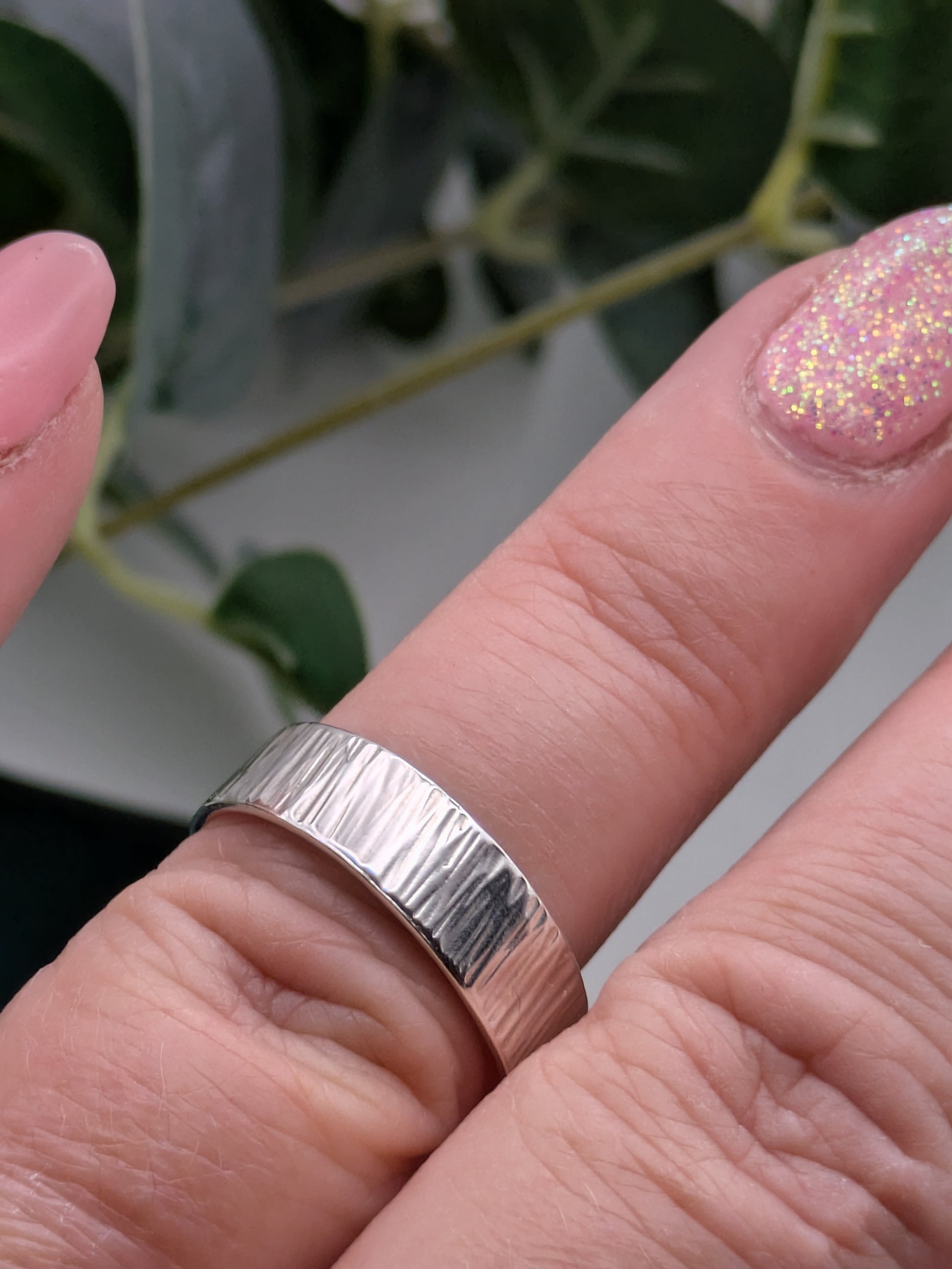 <img src="bark-effect-ring.jpg" alt="Handcrafted 6mm sterling silver ring with bark-inspired hammered texture, a bold and earthy statement band made from recycled 925 silver">