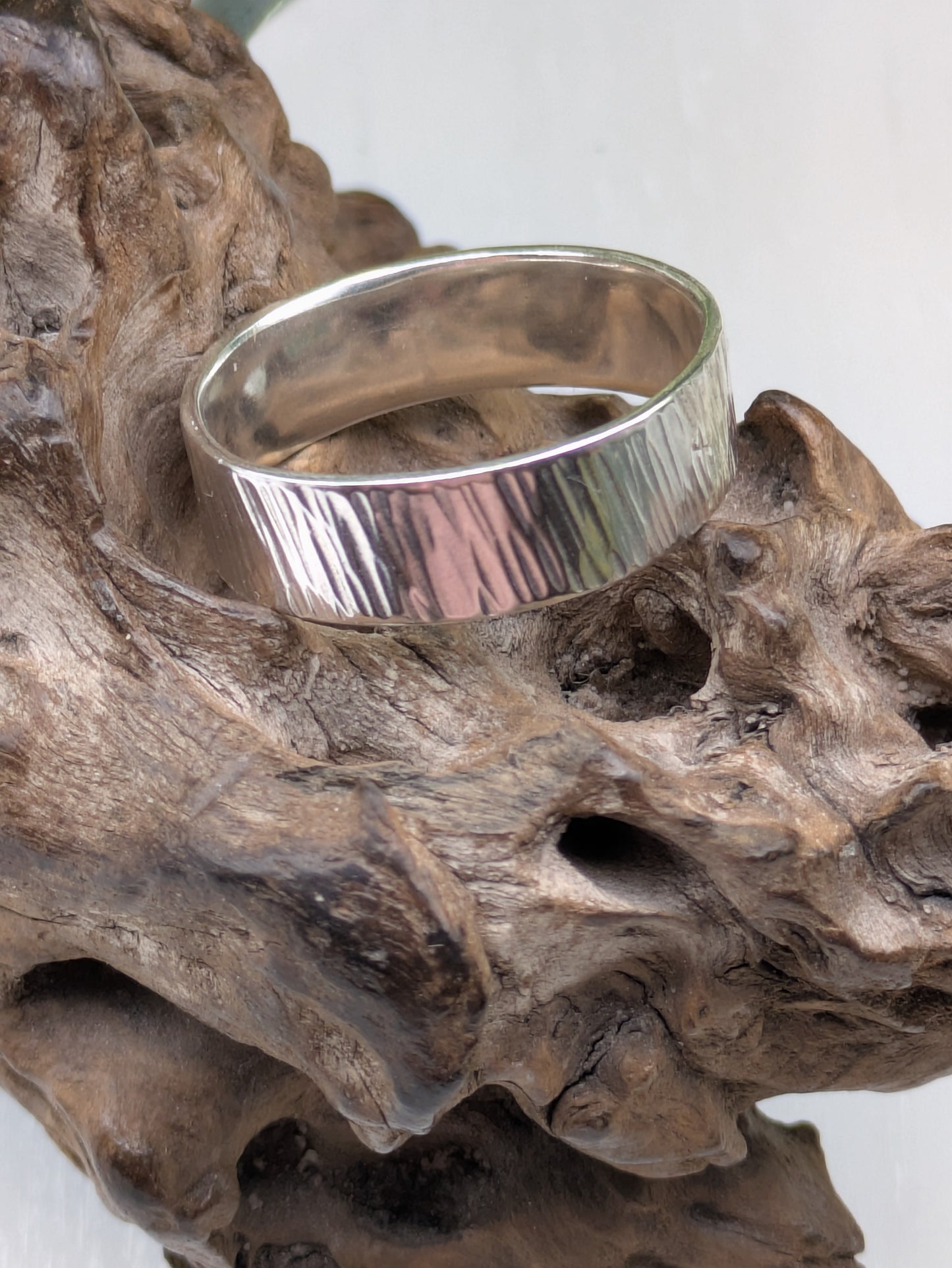 <img src="bark-effect-ring.jpg" alt="Handcrafted 6mm sterling silver ring with bark-inspired hammered texture, a bold and earthy statement band made from recycled 925 silver">