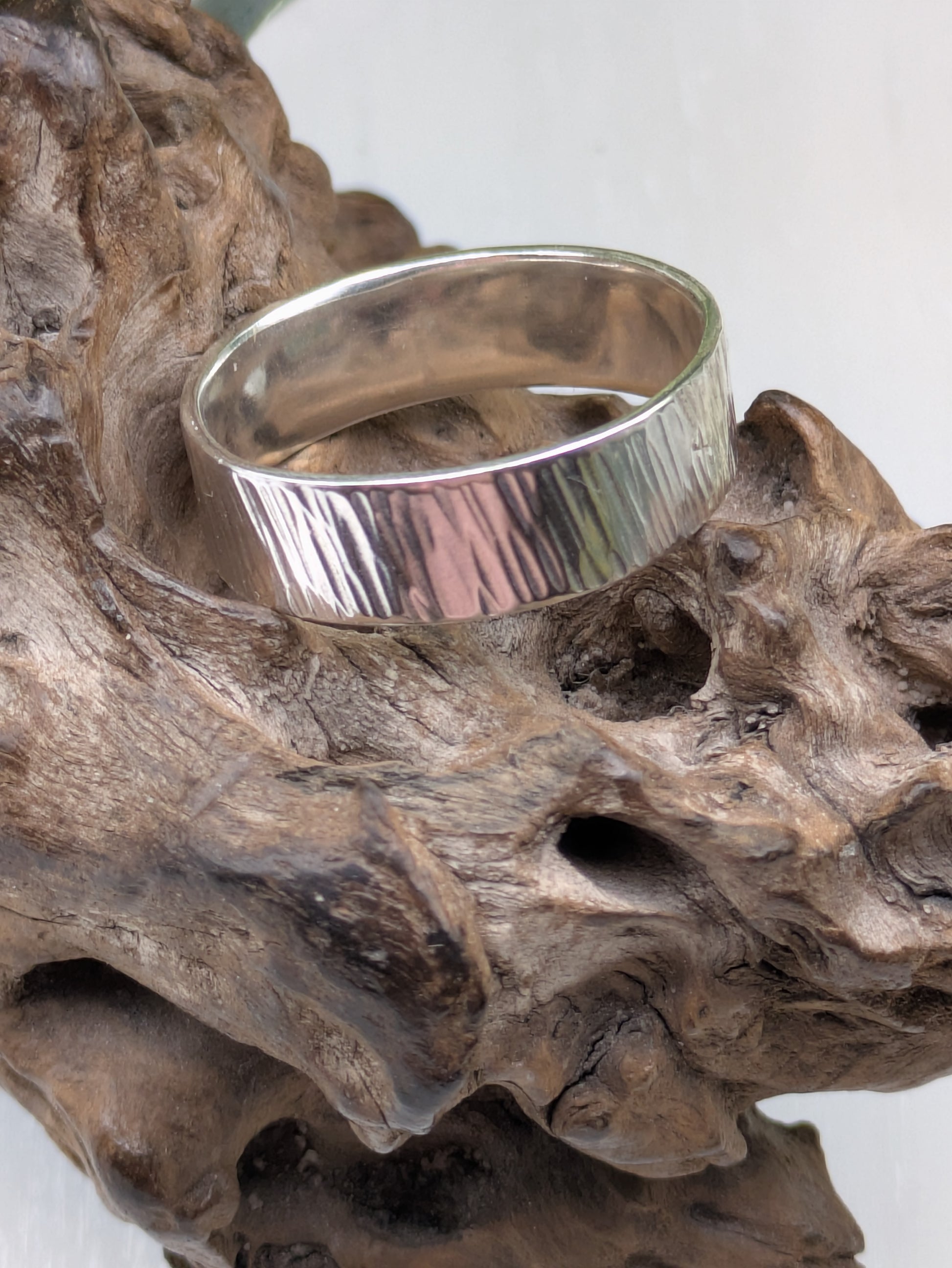 <img src="bark-effect-ring.jpg" alt="Handcrafted 6mm sterling silver ring with bark-inspired hammered texture, a bold and earthy statement band made from recycled 925 silver">