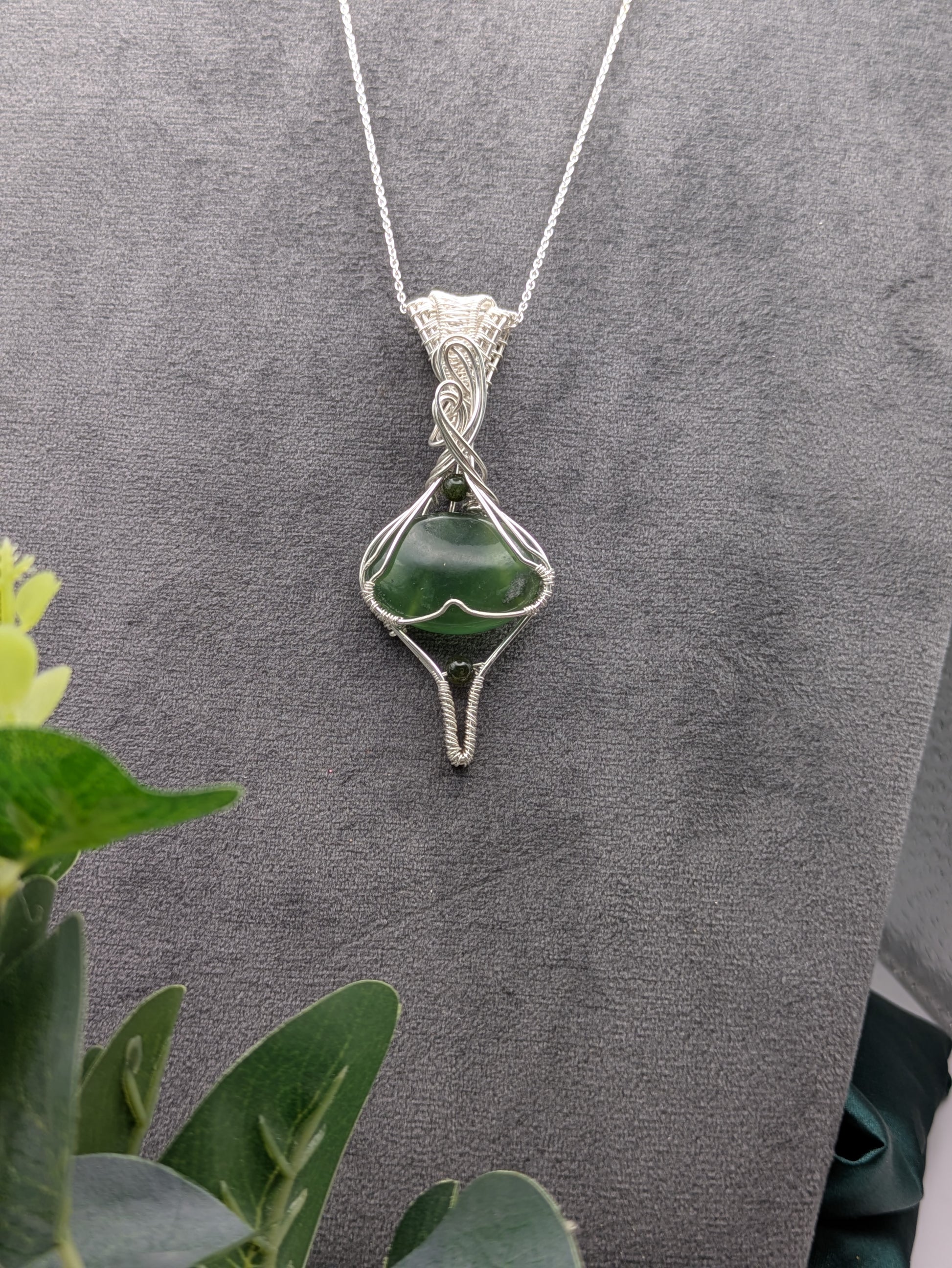 <img src="indonesian-jade-pendant.jpg" alt="Handmade Indonesian jade pendant wrapped in recycled sterling silver, a unique statement crystal necklace inspired by nature">