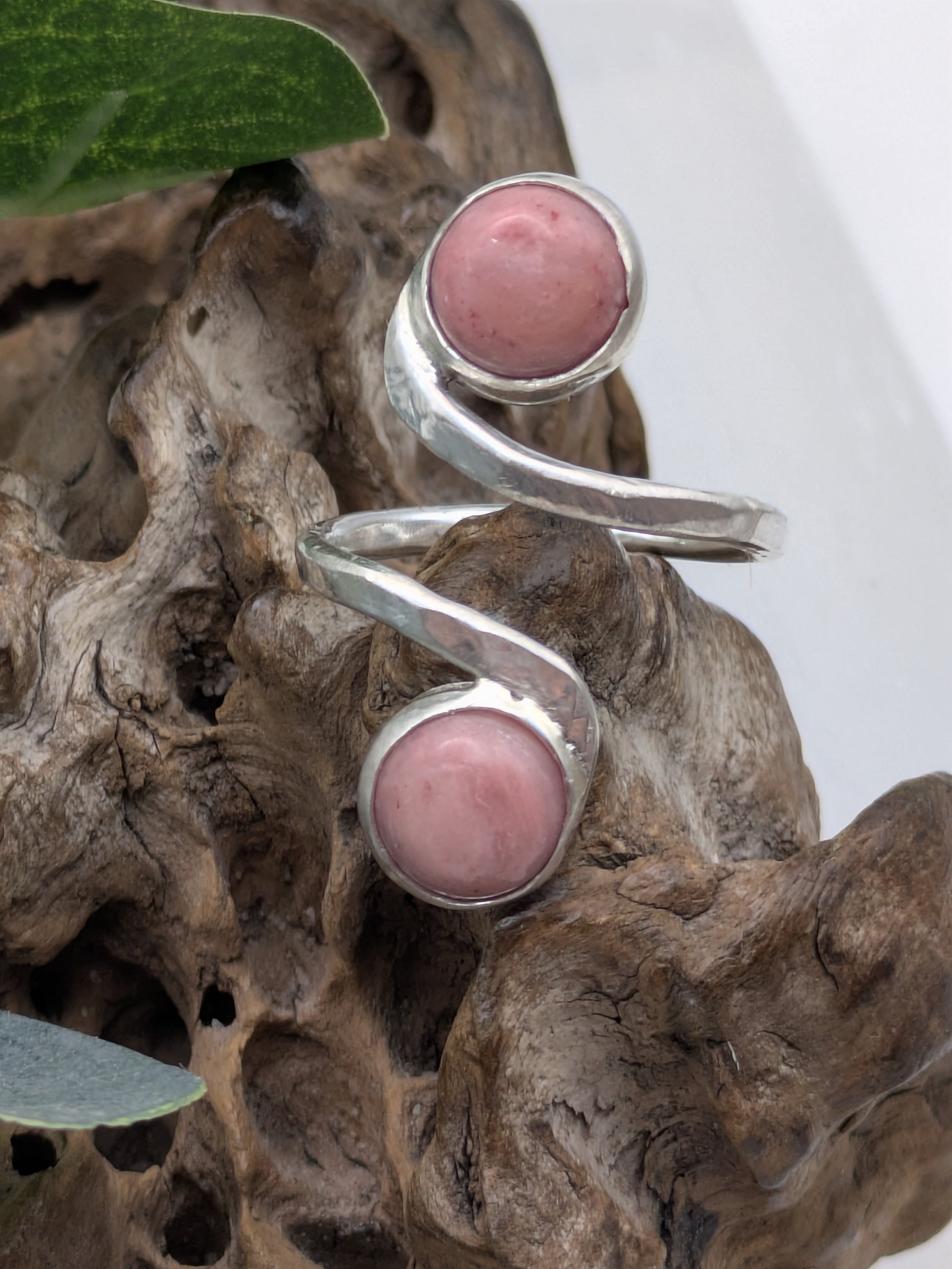 <img src="rhodonite-ring.jpg" alt="Handmade rhodonite ring in recycled sterling silver with hammered texture, a natural pink gemstone piece for emotional balance and self-love">