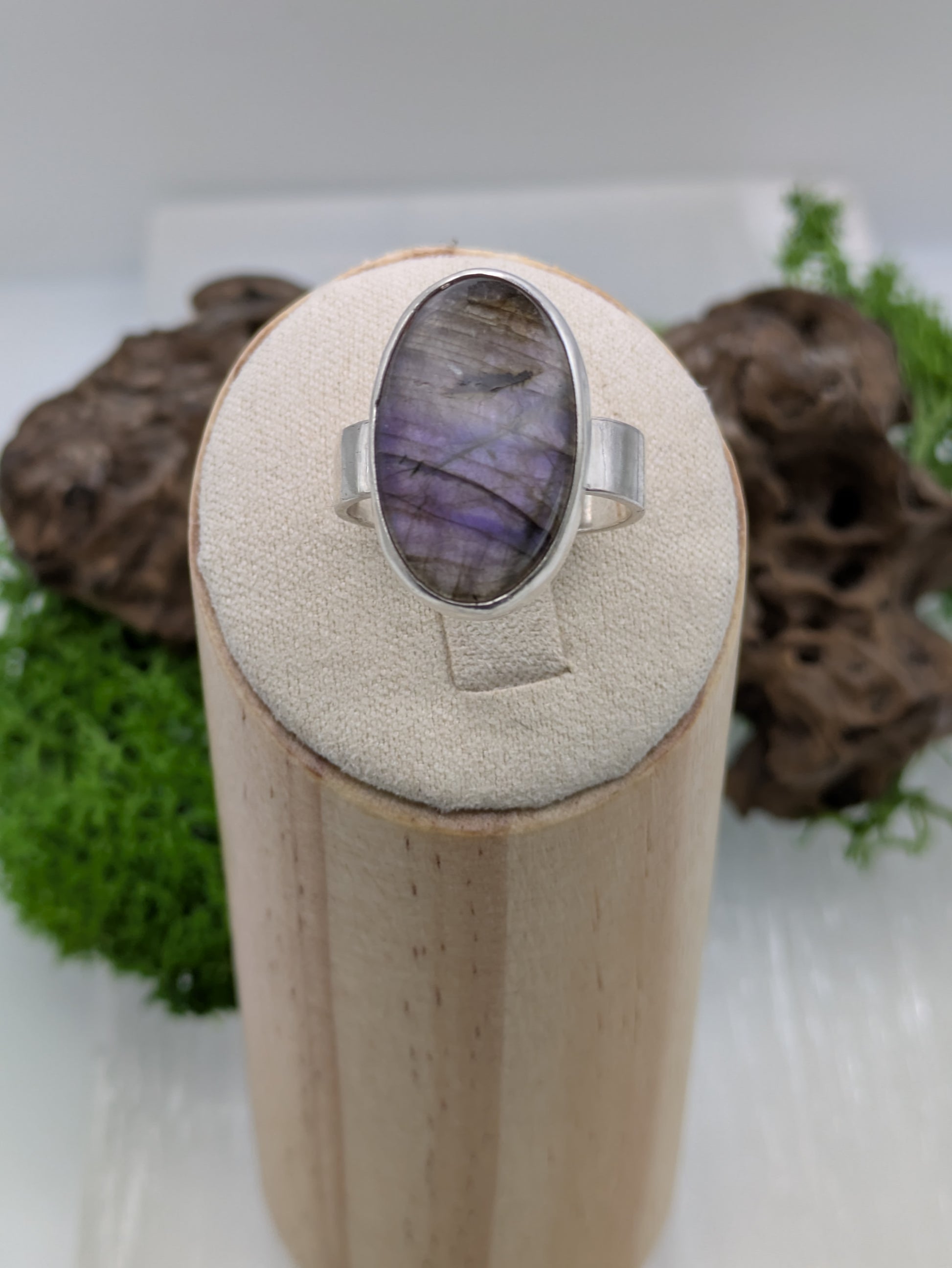 Sterling silver ring featuring a luminous purple labradorite with violet and silver flashes, fully hallmarked and photographed on a soft neutral background.