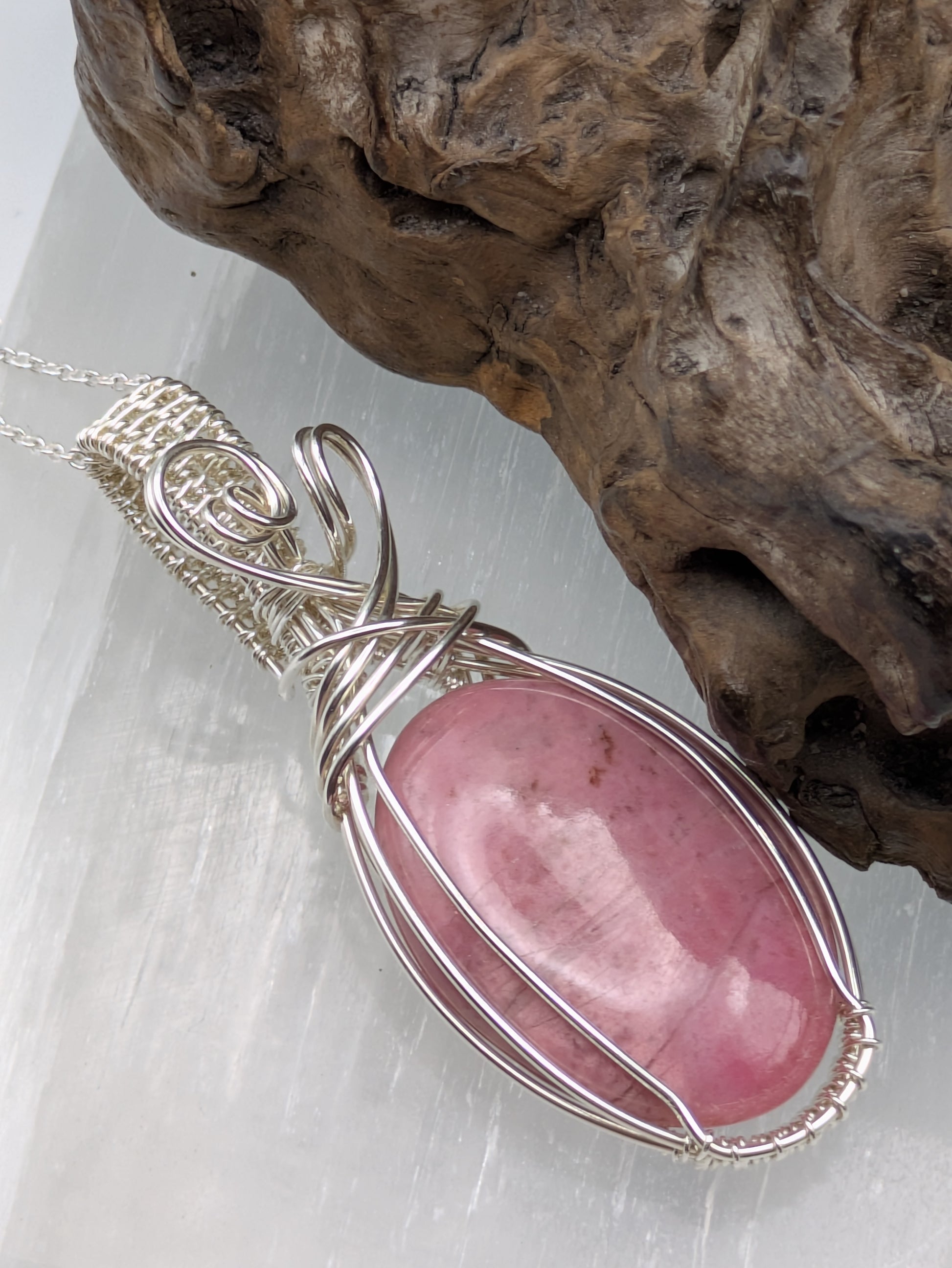 Unique rhodonite crystal pendant wrapped in sterling silver on a handmade necklace