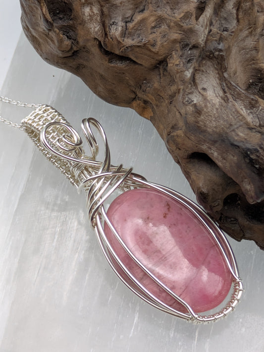 Unique rhodonite crystal pendant wrapped in sterling silver on a handmade necklace