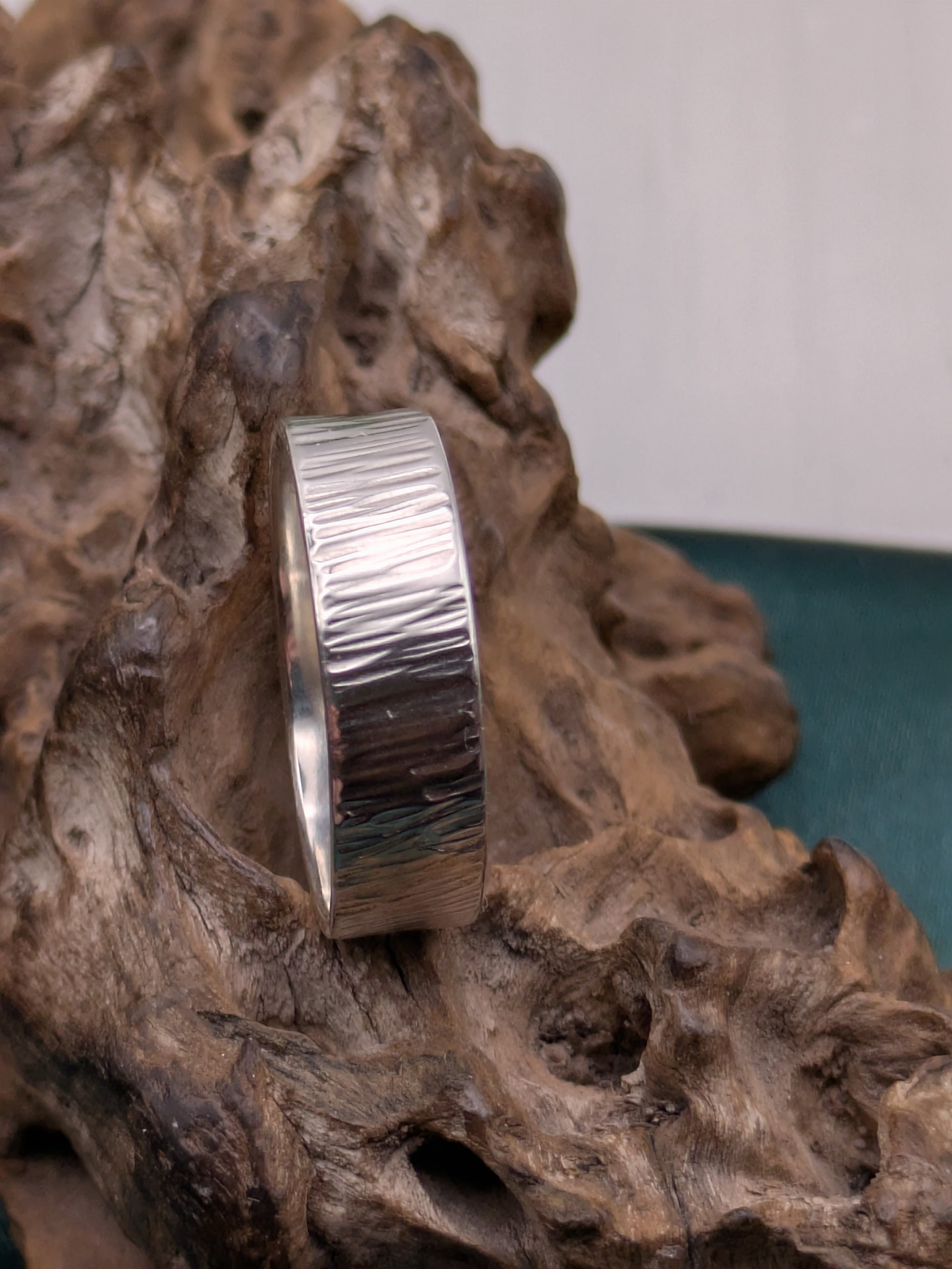<img src="bark-effect-ring.jpg" alt="Handcrafted 6mm sterling silver ring with bark-inspired hammered texture, a bold and earthy statement band made from recycled 925 silver">