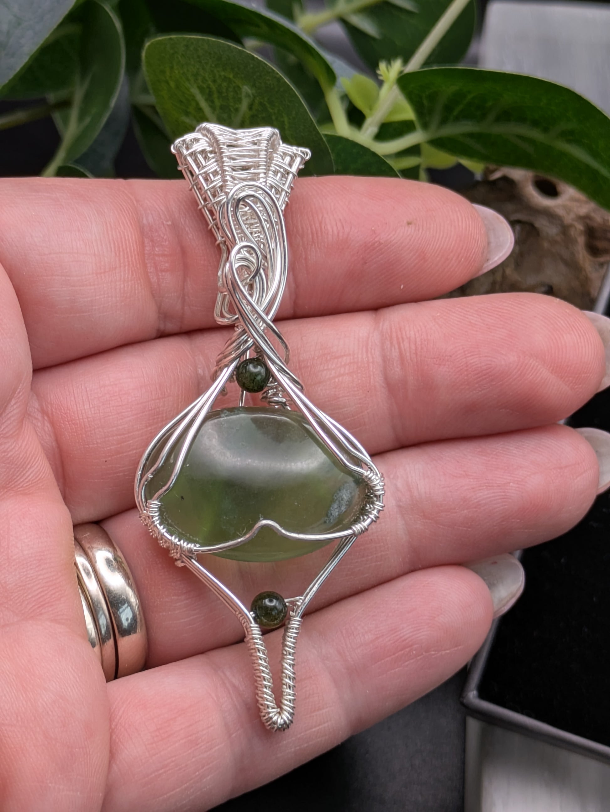 <img src="indonesian-jade-pendant.jpg" alt="Handmade Indonesian jade pendant wrapped in recycled sterling silver, a unique statement crystal necklace inspired by nature">
